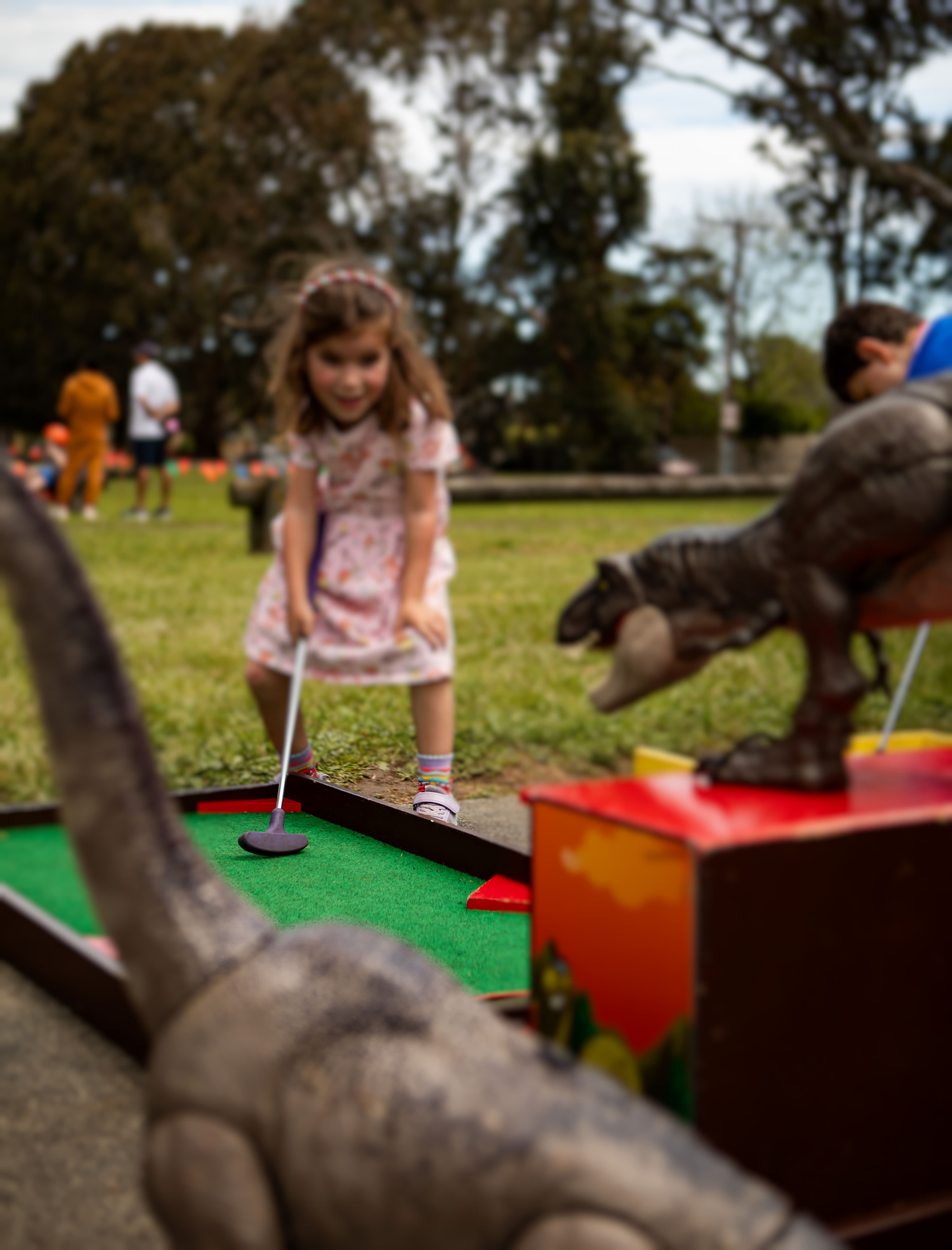 Kids enjoying mini golf at a birthday party