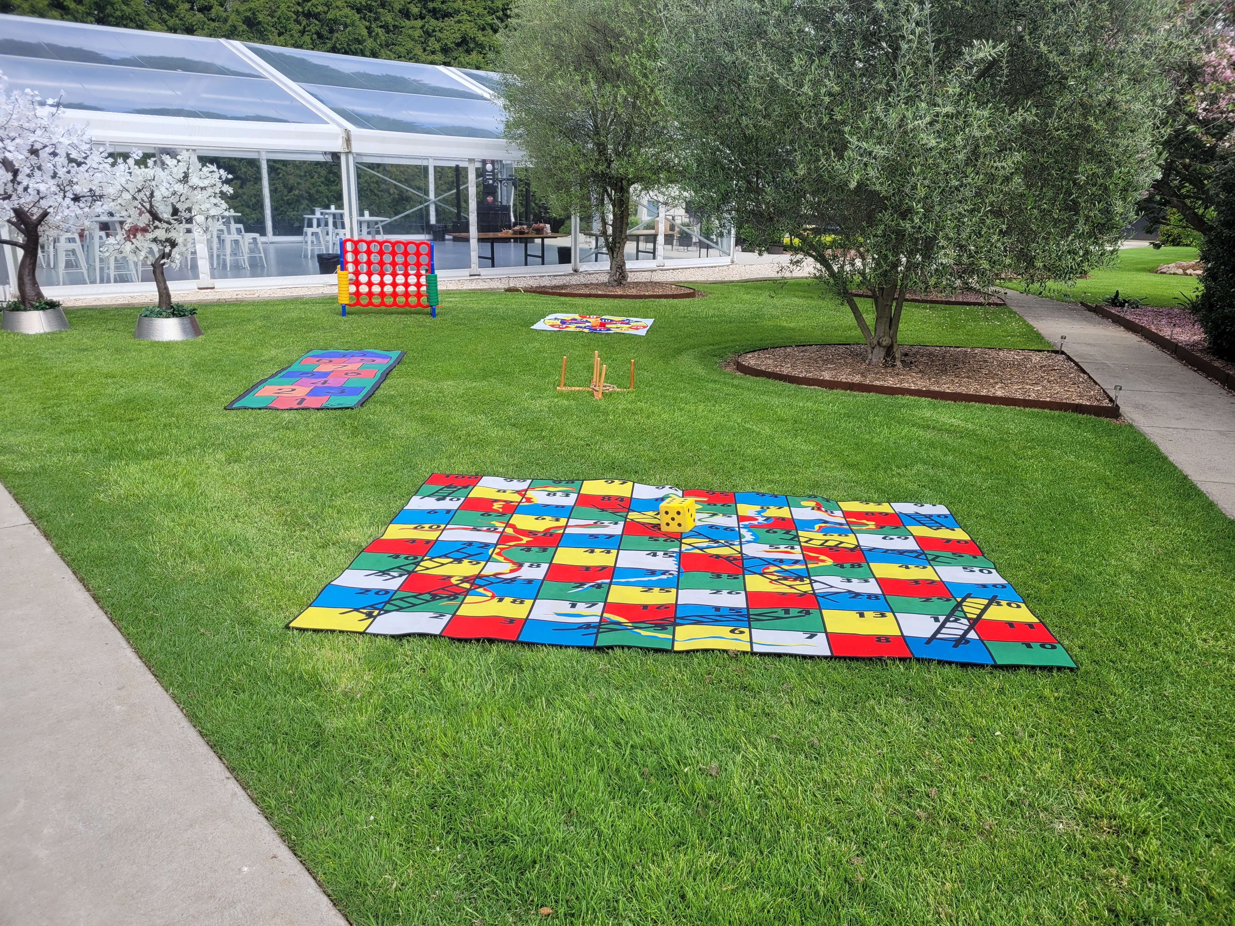 Giant lawn games set up at Melbourne wedding — Snakes & Ladders and Connect Four