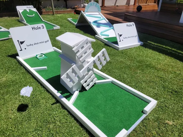 Lucky Shot Mini Golf white picket fence course set up for a Melbourne wedding reception