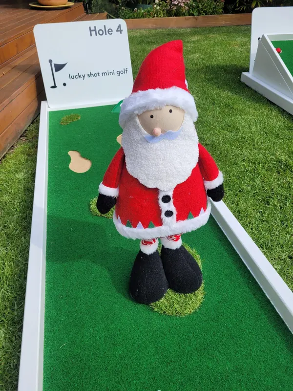 Lucky Shot Christmas themed mini golf with Santa figurine on the windmill obstacle, Melbourne office