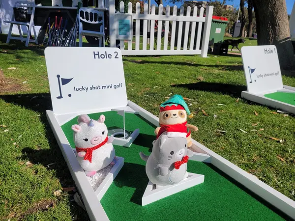 Lucky Shot Christmas themed mini golf with white picket fence, Mario figurines and snowman, Melbourne event