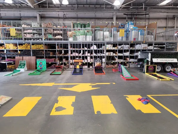 Lucky Shot Mini Golf course inside a Melbourne community library with Pac-Man dots painted along the carpeted holes