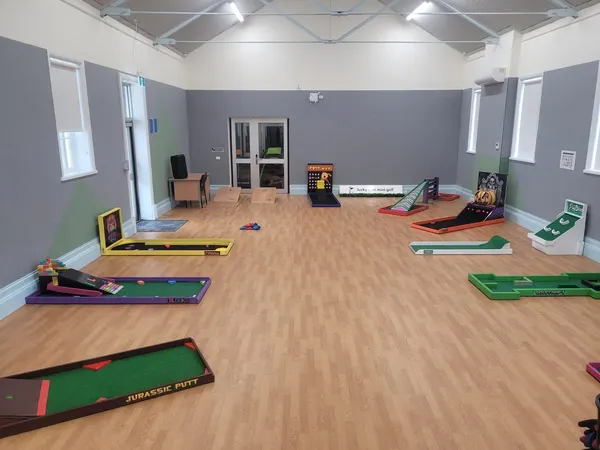 Lucky Shot Mini Golf course set up in a bright open-plan Melbourne office space