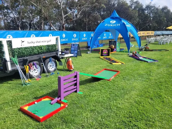 Lucky Shot Mini Golf with inflatable whale obstacle set up at a Melbourne park kids party