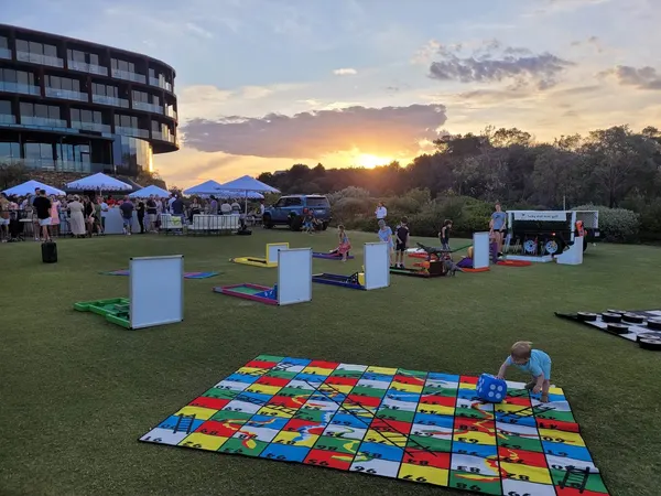 Lucky Shot Mini Golf large outdoor event at sunset with a Melbourne crowd gathered around the course