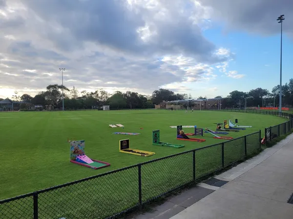 Lucky Shot Mini Golf themed course on a Melbourne AFL field with goal posts visible behind