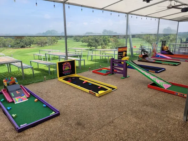 Lucky Shot Mini Golf course on Melbourne parkland with city skyline and Rod Laver Arena visible in the background