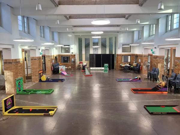 Lucky Shot Mini Golf course laid out inside a bright Melbourne community hall ready for a corporate event