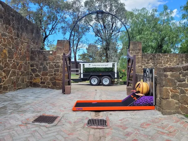 Lucky Shot Mini Golf branded trailer and course set up at a Melbourne outdoor venue