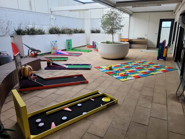 Lucky Shot Mini Golf course set up in a Melbourne corporate lounge area with sofas alongside