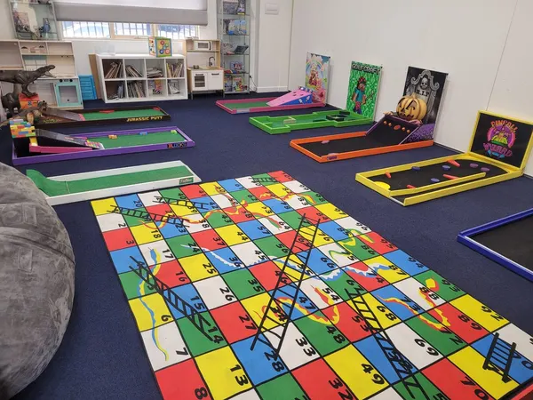 Lucky Shot Mini Golf course set up along a Melbourne office corridor with branded signage
