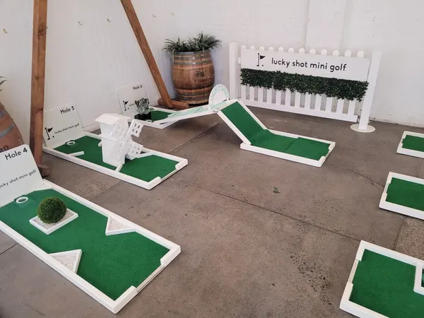 Lucky Shot Mini Golf course inside a low-ceiling Melbourne corporate venue, full nine holes laid out