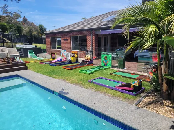 Lucky Shot Mini Golf set up in a Melbourne backyard next to a swimming pool for a kids birthday party
