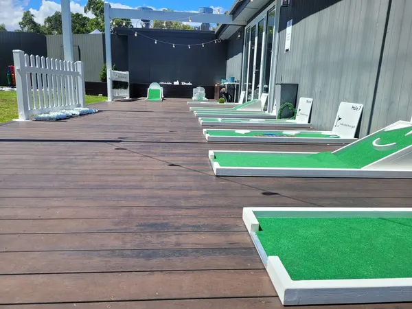 Lucky Shot Mini Golf course set up on a wooden deck patio at a Melbourne corporate venue with skyline views