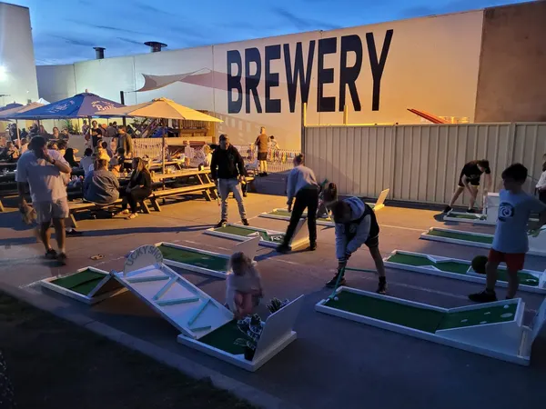 Lucky Shot Mini Golf course set up at a Melbourne brewery corporate venue during golden hour