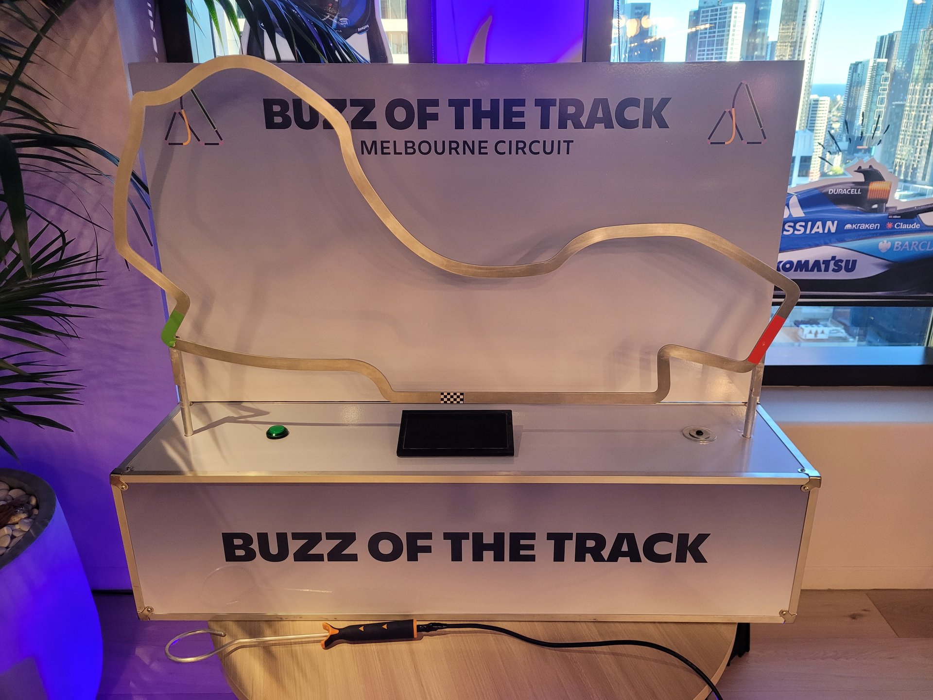 Benchtop buzz wire reaction game on a conference booth tabletop