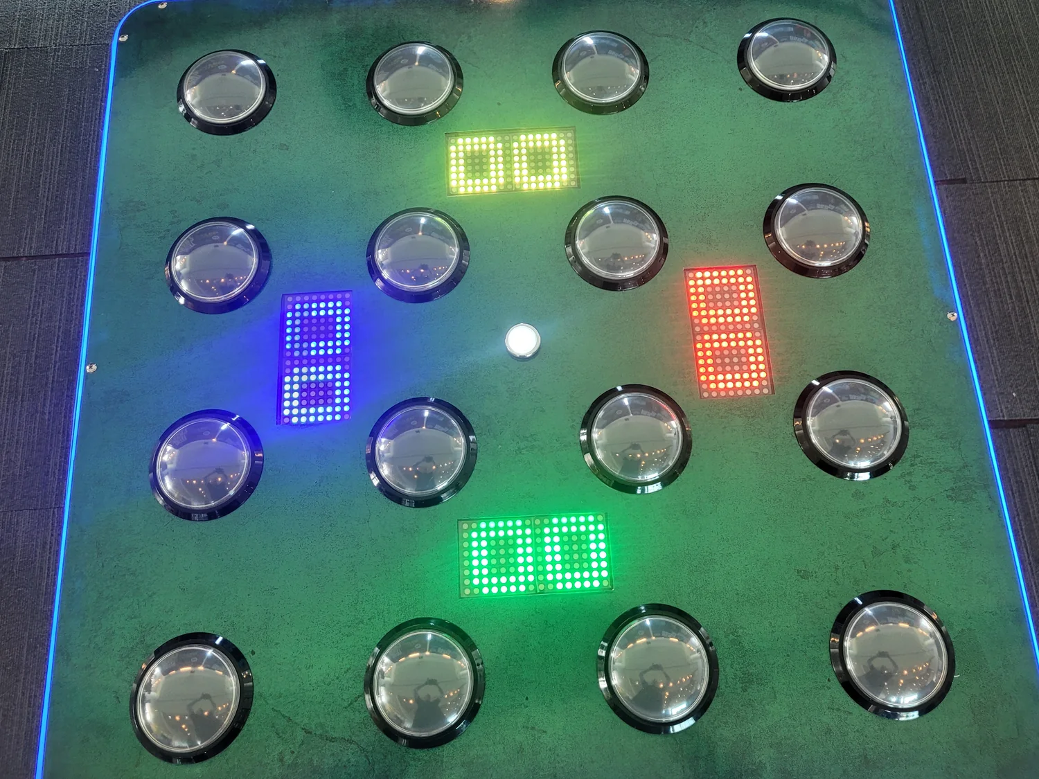 Chaos four player reaction speed game board, lit buttons and LED scores, at a Melbourne conference booth