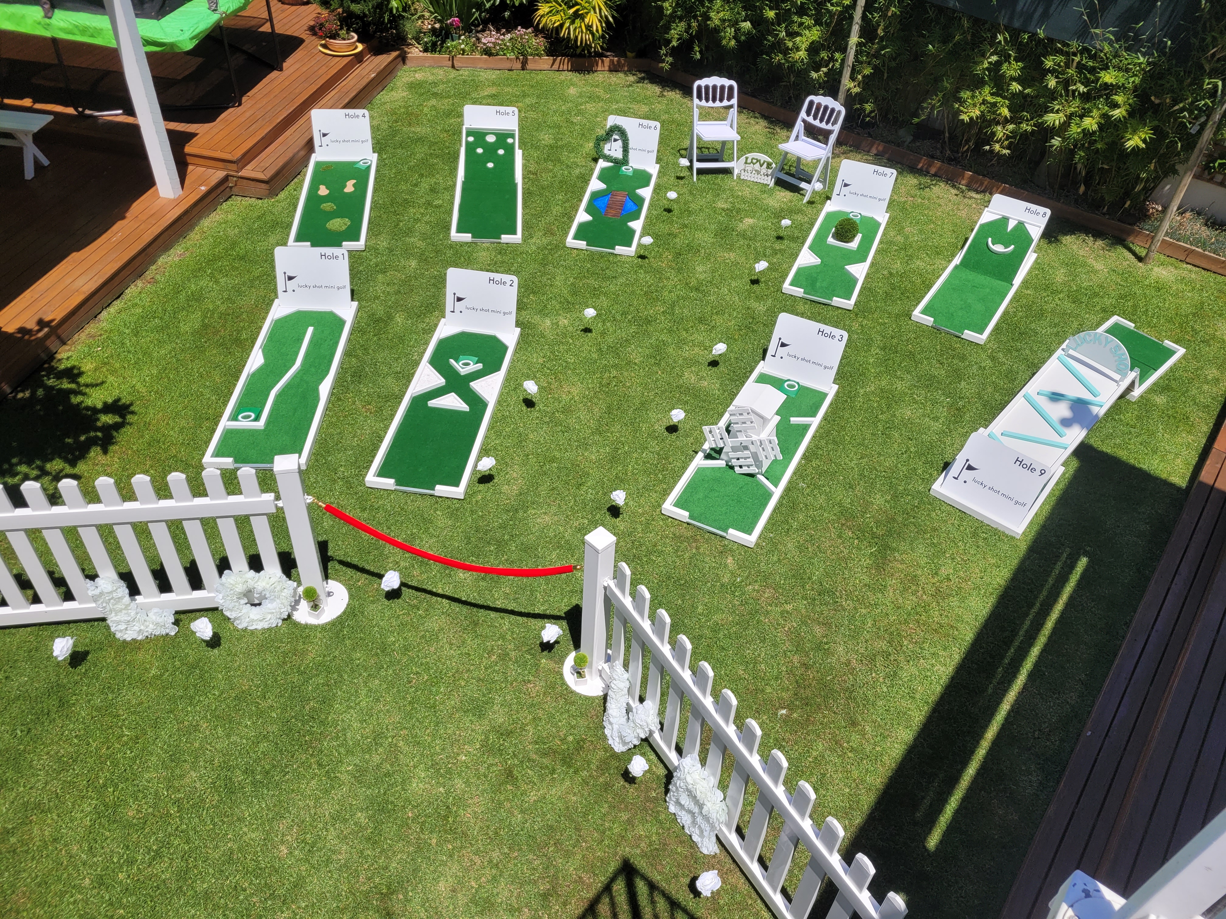 Lucky Shot mini golf with white picket fence at Melbourne backyard wedding